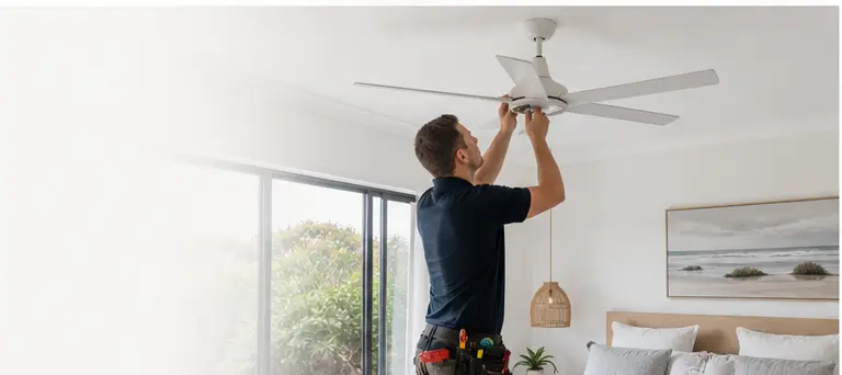 Electrician carrying out practical in-home electrical work in a bedroom setting