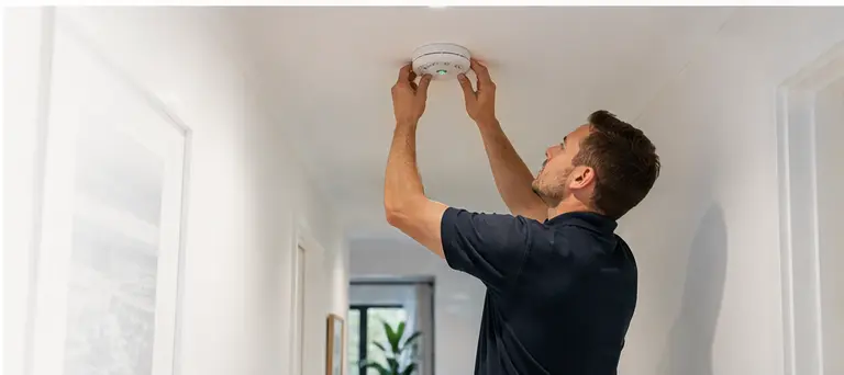 Electrician carrying out tidy residential electrical work in a hallway setting